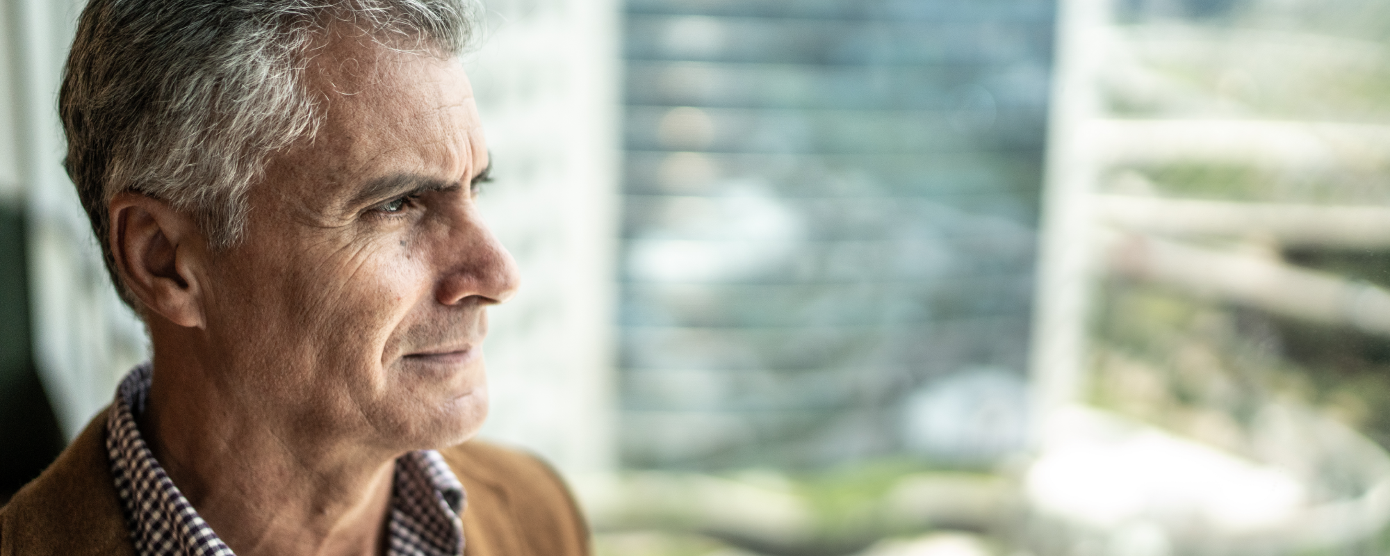 Man looking out of his window