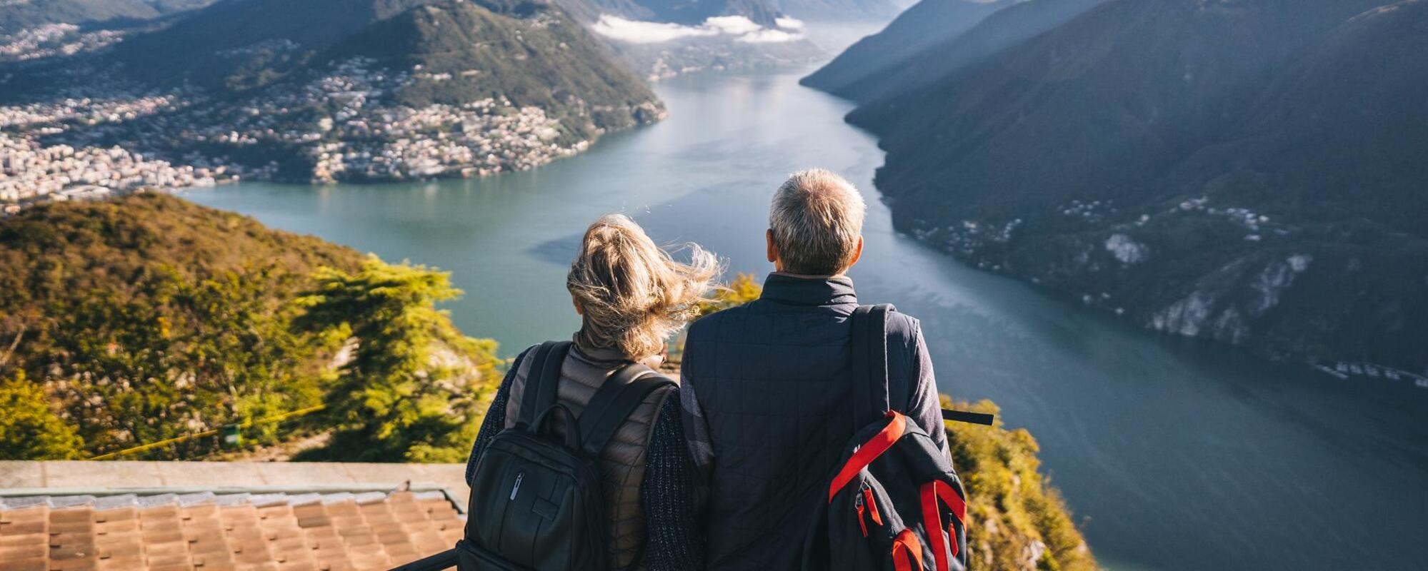 Couple hiking looking at river vista