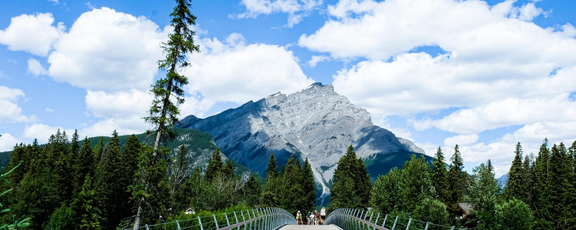 Bridge over river with mountains in the distance