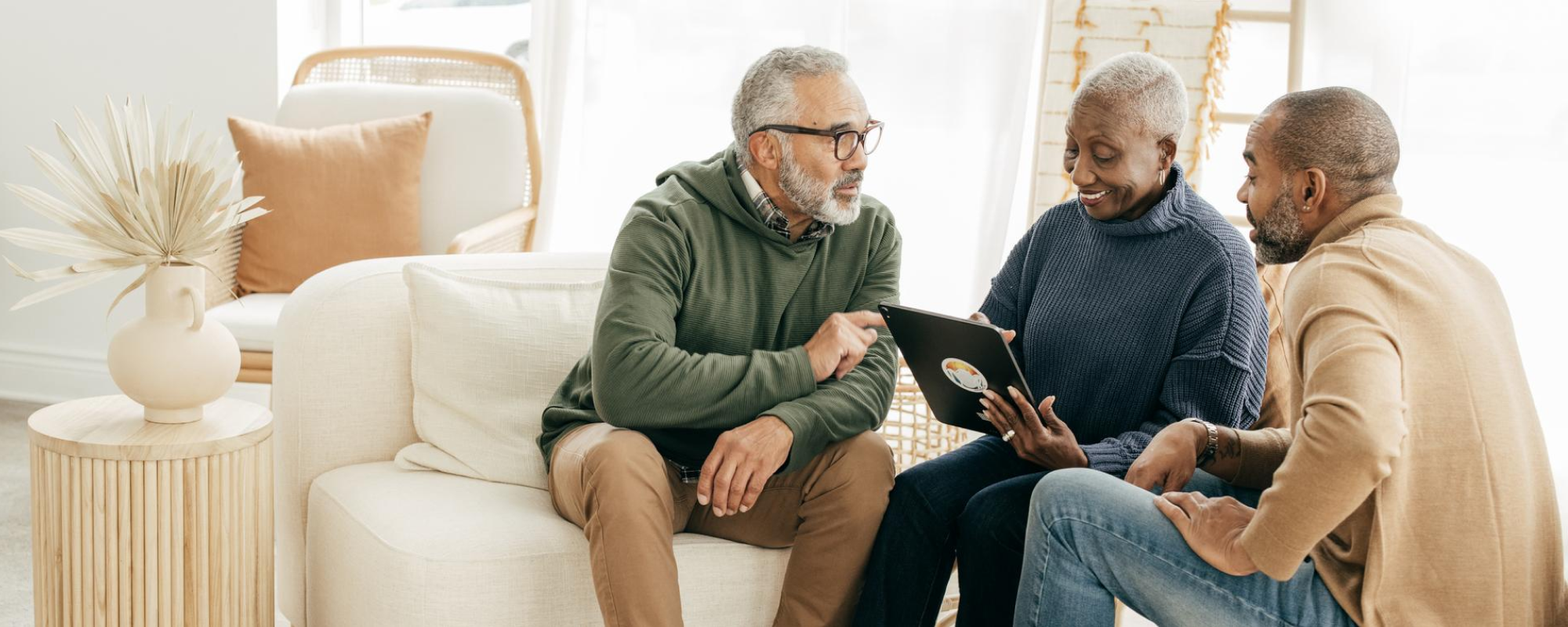 couple speaking to person with iPad
