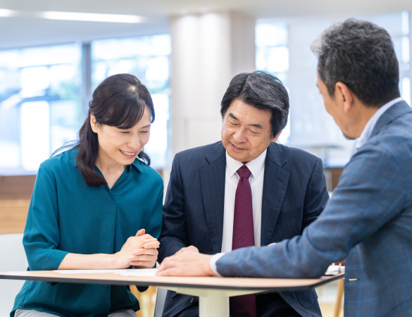 three people in a meeting