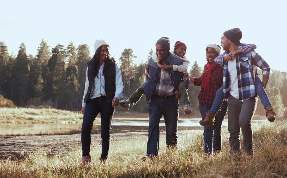 family of six laughing in an open field