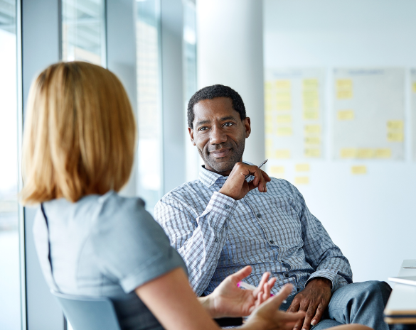 man and woman sitting across from each other having a conversation