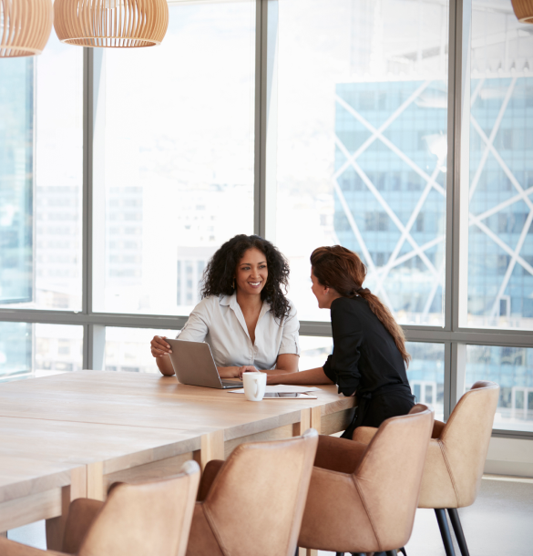two people talking in a conference room