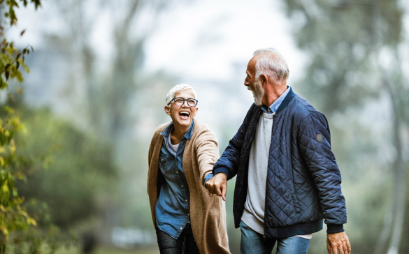 elderly couple hiking through a forest