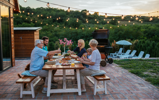 family of six eating at a picnic table outside