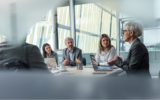 group of people sitting in a meeting room