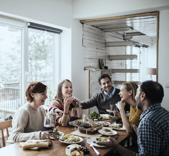 family of 5 share a meal around a table