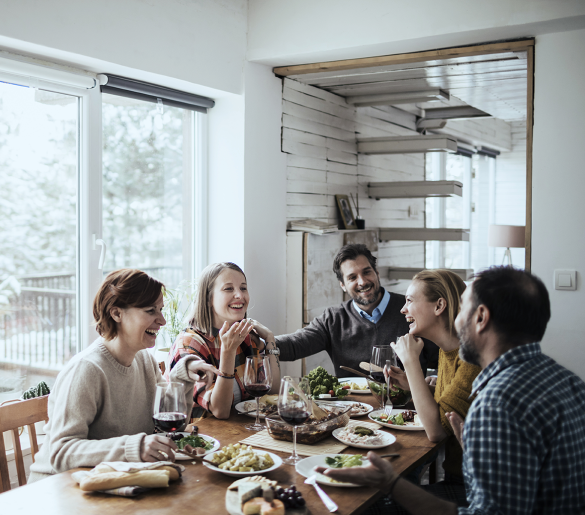 family of 5 share a meal around a table