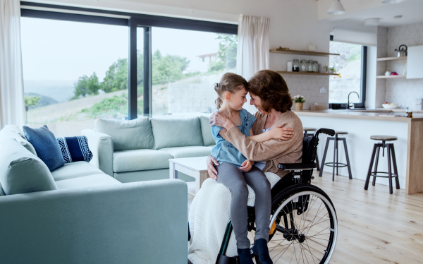 woman hugs her child in her lap