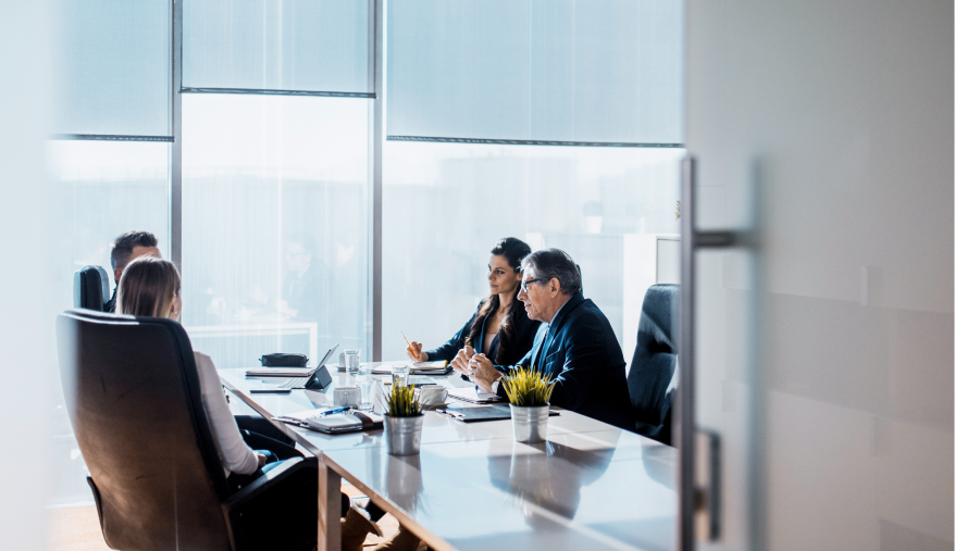 group of people sitting in a board room