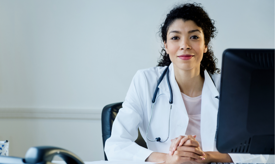 doctor sitting at desk with computer