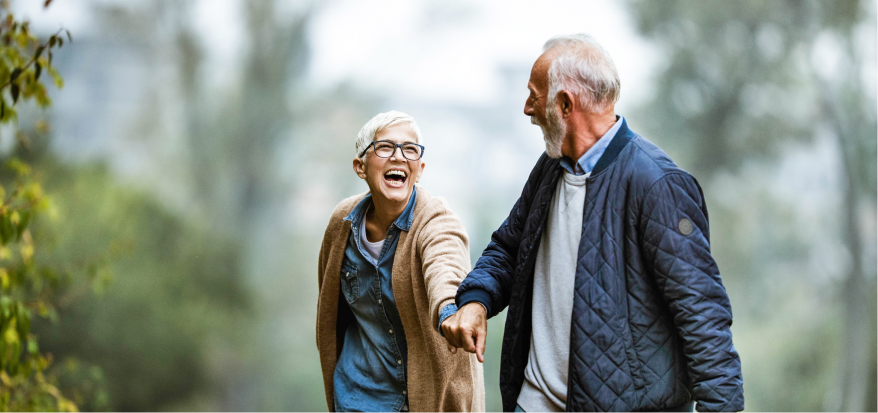 man and woman holding hands while hiking